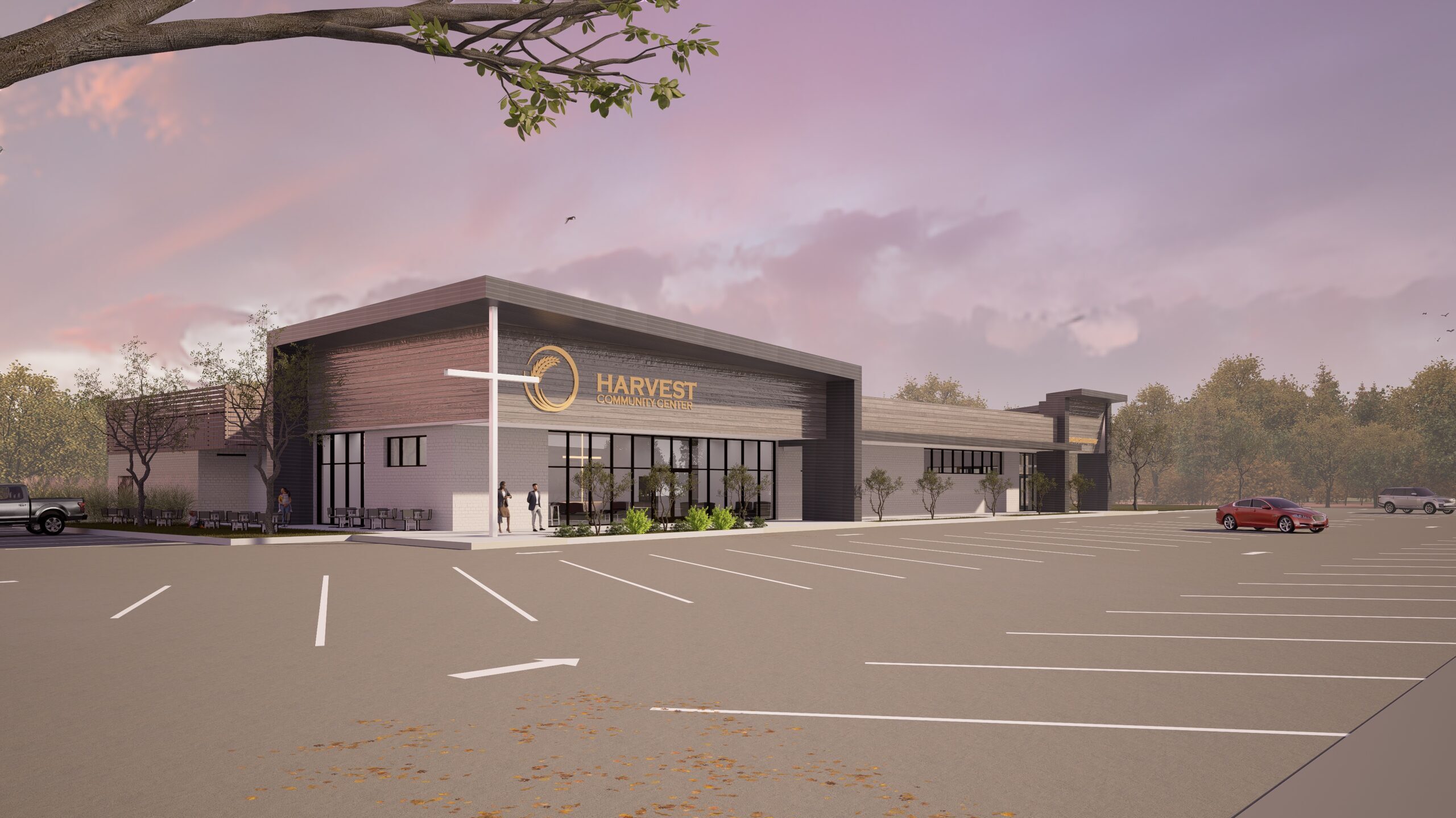 Contemporary exterior of Harvest Community Church Lafayette facility featuring modern gray and wood facade, large glass entry, cross element, and welcoming parking area by Lafayette architect
